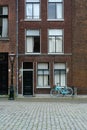A blue bicycle is standing on a Dutch street. Old classic holland street with a blue bike Royalty Free Stock Photo