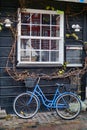Blue bicycle under a window with sailboat and reflection in Copenhagen Royalty Free Stock Photo