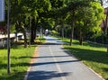 Blue bike path through a public park with lawns and trees Italy, Europe Royalty Free Stock Photo