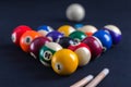 Blue billiard table with balls and cues.