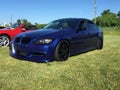 Blue bimmer with black rims at a car meet