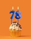 Blue candle number 78 - Birthday cupcake on orange background