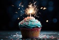 a blue birthday cupcake with a sparkler in the middle Royalty Free Stock Photo