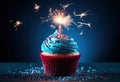 a blue birthday cupcake with a sparkler in the middle Royalty Free Stock Photo