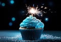 a blue birthday cupcake with a sparkler in the middle Royalty Free Stock Photo