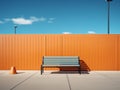 a blue and black bench sitting in front of an orange wall