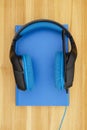 Blue and black headset with microphone with a book Royalty Free Stock Photo