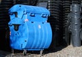 Blue and black municipal waste dust bins