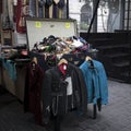 A blue and black rocker leather jacket hangs on the counter. Box of Silk Scarves for Sale at Spitalfields Antique Market