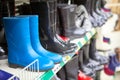 Blue and black waterboots are on shop shelves Royalty Free Stock Photo