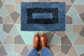 Blue and Black Woolen Door mat with Brown shoes Welcome entry designer doormat Royalty Free Stock Photo