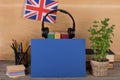 blue blank paper, flag of the Great Britain, headphones, books and chancellery on the table Royalty Free Stock Photo