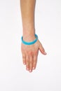 Blue blank rubber wristband on wrist arm. Silicone fashion round social bracelet wear hand. Unity band.