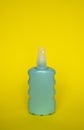 Blue blank unbranded cosmetic plastic bottle for shampoo, gel, lotion, cream, bath foam yellow background. Royalty Free Stock Photo