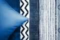 Blue blanket and a blue pillow on it, and bed linen in shades of blue, items bedroom interior Royalty Free Stock Photo