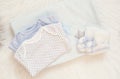 Blue Blanket, Bodysuits, Knitted baby Boots And Bunny Toy On A White Fur Carpet. Baby Mockup. Newborn  Concept. Baby Boy Shower Royalty Free Stock Photo