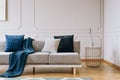 Blanket on grey couch in elegant living room interior Royalty Free Stock Photo