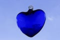 A blue blood heart, with the sky in the background