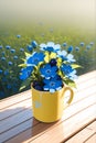 Blue blossoms in a shunshine mug Royalty Free Stock Photo