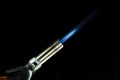 A blue blowtorch tool in action with his blue flame Royalty Free Stock Photo