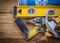 Blue blueprints construction level try square claw hammer pliers Royalty Free Stock Photo