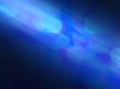 Blue blurred and abstract background with a shaft of light rays going through it. Universe, meteor or planet concept. Royalty Free Stock Photo