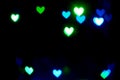 Blue blurred lights in the shape of hearts in the dark Royalty Free Stock Photo