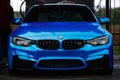 Blue BMW M4 F83 wrapped in blue chrome wrap vinyl on Drift And Car Show. Luxury German vehicle with led Royalty Free Stock Photo