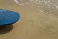 Blue board and footprint in the sand Royalty Free Stock Photo