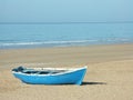 A blue boat on a beach