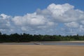 Blue boat, on beautiful blue sky and cotton-clouds background at Ponta do Muta, Barra Grande, Marau Peninsula, Bahia State, Brazil