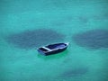 Blue boat in blue bay Royalty Free Stock Photo