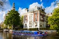 Blue boat company canal trip in Amsterdam city, Netherlands Royalty Free Stock Photo