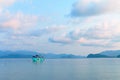 A blue boat float in the sea of Gulf of Thailand that surrounded by mountains Royalty Free Stock Photo