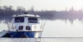 Blue boat on misty lake at low dusk sun Royalty Free Stock Photo