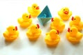 Cute yellow rubber ducks and blue paper ship. Royalty Free Stock Photo