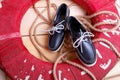 Blue boat shoes on wooden background near red lifebuoy and rope Royalty Free Stock Photo