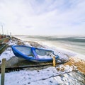 Blue boat on the shore of the frozen sea Royalty Free Stock Photo