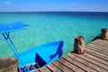 Blue boat in wooden tropical pier in Caribbean Royalty Free Stock Photo