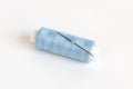Blue bobbin of thread with needle on white Royalty Free Stock Photo
