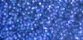 Blue bokeh holiday textured glitter background. Blurred abstract holiday background Royalty Free Stock Photo