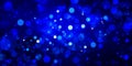 Blue bokeh lights in blurred background design with black shadows and white shining circles, glitter or sparkle Royalty Free Stock Photo