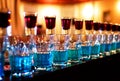 Blue bomb drinks shot glasses standing on the counter falling