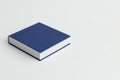 A blue book on a light background. Space for text. Royalty Free Stock Photo