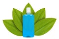 Blue bottle with mouthwash on the background of green leaves. Isolated on white. concept of natural origin