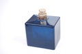 Blue bottle of perfume without cover on a white background. Royalty Free Stock Photo