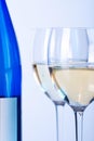 Blue bottle of white wine and two wine glasses Royalty Free Stock Photo
