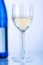 Blue bottle of white wine and two wine glasses Royalty Free Stock Photo