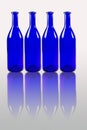 Blue bottles with reflection isolated on white background Royalty Free Stock Photo