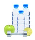 Blue bottles with water, chromed fitness dumbbells, lime